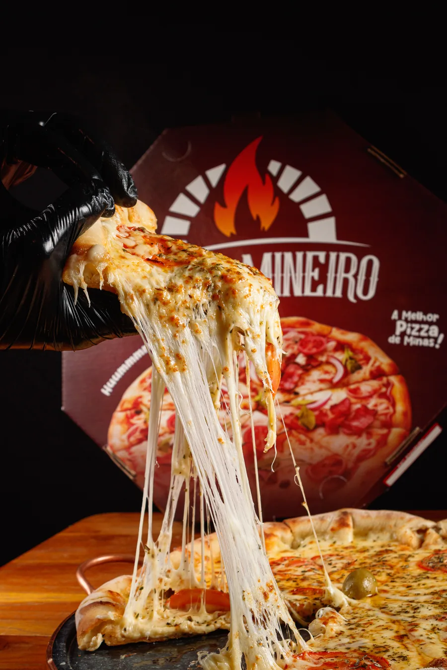 Fatia de pizza sendo servida ainda quente